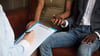 Couple sitting in appointment with interlocked hands